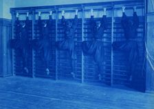 Girls in bloomers on climbing apparatus, Western High School, Washington, D.C., (1899?). Creator: Frances Benjamin Johnston