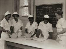 Girls instructed in pastry making at Colored Household Training School, 1937. Creator: Wilson