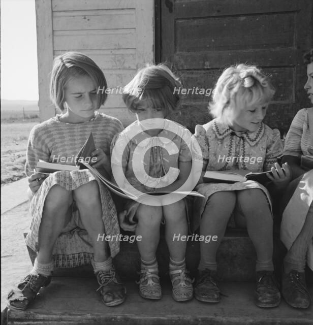 Girls of Lincoln Bench School study their reading lesson, near Ontario, Malheur County, Oregon, 1939 Creator: Dorothea Lange.