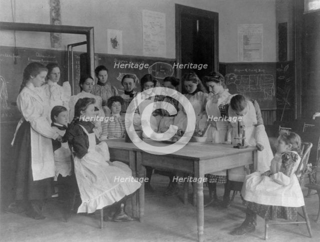 Girls posed in home economics class, 1st Division, Washington, D.C., (1899?). Creator: Frances Benjamin Johnston.