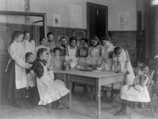 Girls posed in home economics class, 1st Division, Washington, D.C., (1899?). Creator: Frances Benjamin Johnston