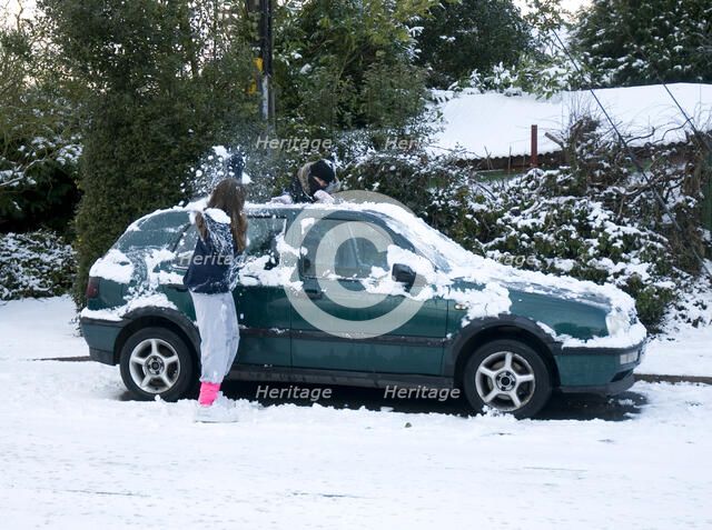 Girls palying with snowballs by VW Golf 2009 Artist: Unknown.