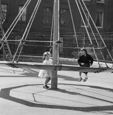 Girls playing on a witch's hat in a playground, London, 1960-1965. Artist: John Gay