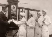 Girls queue at the Clocking-In machine, Rowntree factory, York, Yorkshire, 1933
