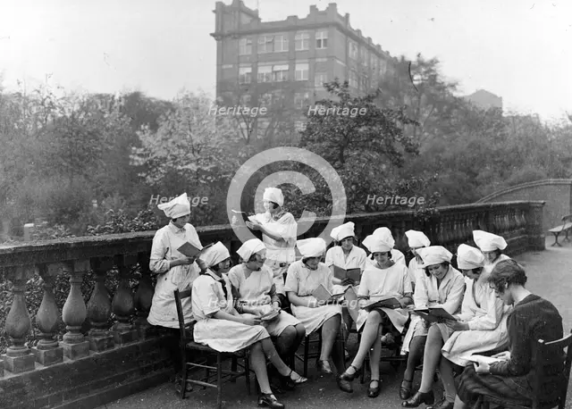 Girls read in an outdoor class, Rowntree factory, York, Yorkshire, 1933. Artist: Unknown