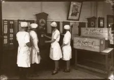 Girls use the clocking in machine, Rowntree factory, York, Yorkshire, 1929