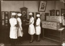 Girls use the clocking in machine, Rowntree factory, York, Yorkshire, 1929
