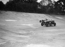 GL Baker's 5954 cc Minerva racing a 1930 Frazer-Nash Sportop on the banking at Brooklands. Artist: Bill Brunell