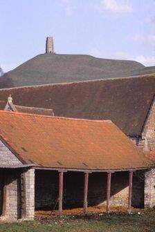 Glastonbury Tor and Ancient Tithe Barn, Somerset, 20th century. Artist: CM Dixon