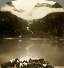 Grytereids glacier glittering above drifting clouds, across placid Lake Olden, Norway c1905. Creator: Unknown