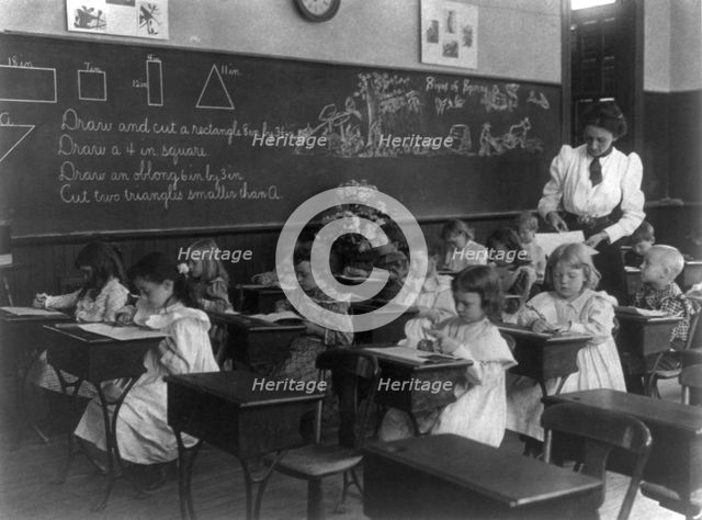 Grade school, Washington, D.C. - children drawing and cutting rectangles, triangles, etc., (1899?). Creator: Frances Benjamin Johnston.