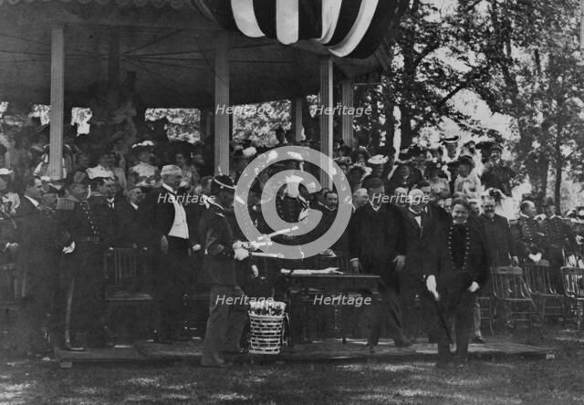 Graduation Day at Annapolis - cadet receiving his diploma from President Theodore Roosevelt, 1902. Creator: Frances Benjamin Johnston.