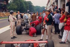 Graham Hill watches Mechanics working on a car, French Grand Prix, Rouen, 1968