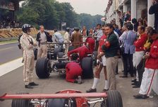 Graham Hill watches Mechanics working on a car, French Grand Prix, Rouen, 1968