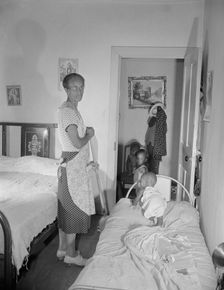 Grandchild of Mrs. Ella Watson, a government charwoman, taking her...nap, Washington, D.C, 1942. Creator: Gordon Parks