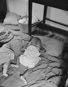 Grandchild of Mrs. Ella Watson, a government charwoman, taking her...nap, Washington, D.C., 1942. Creator: Gordon Parks
