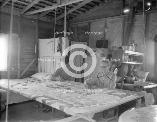 Grandmother from Oklahoma with grandson, working on quilt, California, Kern County, 1936. Creator: Dorothea Lange.