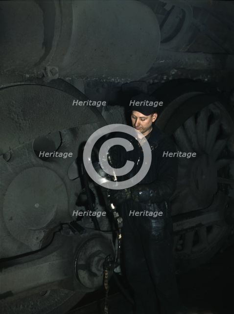 Greasing a locomotive in the roundhouse at Proviso (?) yard, C & NW RR, Chicago, Ill., 1942. Creator: Jack Delano.