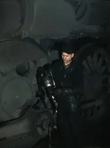 Greasing a locomotive in the roundhouse at Proviso (?) yard, C & NW RR, Chicago, Ill., 1942. Creator: Jack Delano
