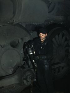 Greasing a locomotive in the roundhouse at Proviso (?) yard, C & NW RR, Chicago, Ill., 1942. Creator: Jack Delano