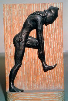 Greek bronze hoplite putting on armour, 5th century BC