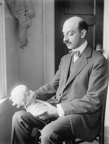 Greek Statuette Held By A.C. Vouros, 1913. Creator: Harris & Ewing