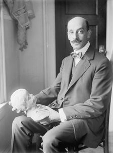 Greek Statuette Held By A.C. Vouros, 1913. Creator: Harris & Ewing