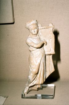 Greek Terracotta, Woman playing Kithera with plectrum, 3rd century BC-2nd century BC