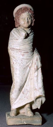 Greek terracotta figure of a boy, said to be from Tanagra, Boeotia, Greece, c300BC- 250BC