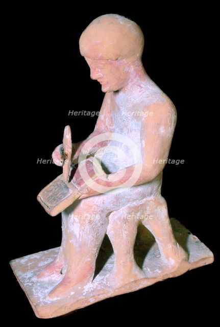 Greek terracotta of a man writing. Artist: Unknown