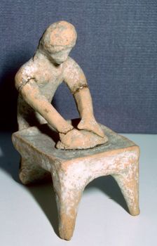 Greek terracotta of a woman making bread