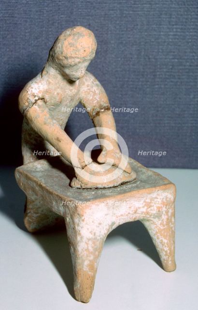 Greek terracotta of a woman making bread. Artist: Unknown