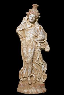 Greek terracotta of a woman in a flowing dress