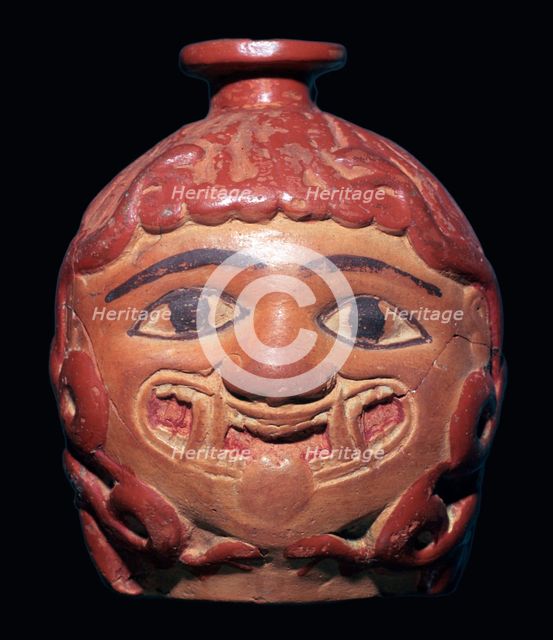 Greek terracotta scent bottle in the shape of a gorgon's head made in Rhodes. Artist: Unknown