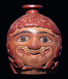 Greek terracotta scent bottle in the shape of a gorgon's head made in Rhodes