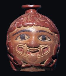 Greek terracotta scent bottle in the shape of a gorgon's head made in Rhodes