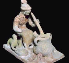 Greek terracotta statuette of a woman cooking
