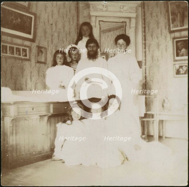 Grigory Rasputin with Empress Alexandra Fyodorovna, her five children and seated right governess Mar