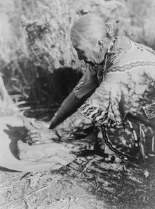 Grinding wokas-Klamath, c1923. Creator: Edward Sheriff Curtis