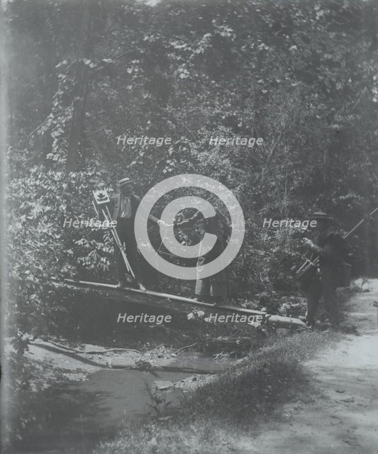 Group crossing footbridge with cameras, between 1885 and 1900. Creator: Frances Benjamin Johnston.