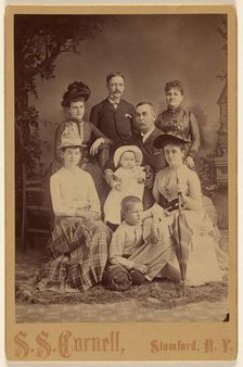 Group family portrait of eight members, 1889. Creator: SS Cornell