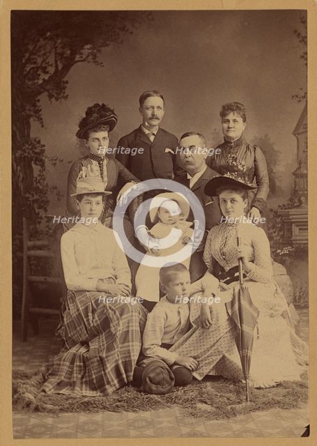 Group family portrait of eight members, 1889. Creator: SS Cornell.