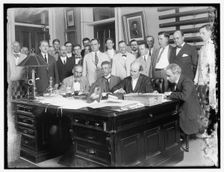 Group: includes William Jennings Bryan (at desk, 2nd from right)..., between 1910 and 1920. Creator: Harris & Ewing