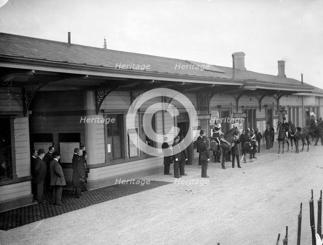 Group, including soldiers and policemen, wait outside Oxford Railway Station, Oxon, c1860-c1922. Artist: Henry Taunt