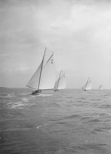 Group of 8 Metres sailing yachts racing downwind, 1913. Creator: Kirk & Sons of Cowes