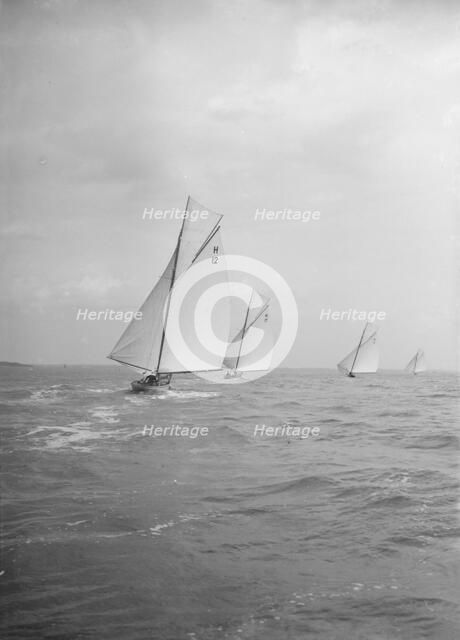 Group of 8 Metres sailing yachts racing downwind, 1913. Creator: Kirk & Sons of Cowes.