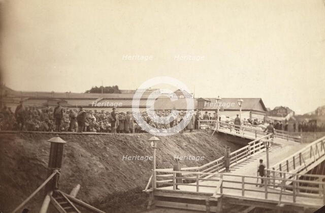 Group of convicts at head of inclined plane leading to barge, between 1885 and 1886. Creator: Unknown.
