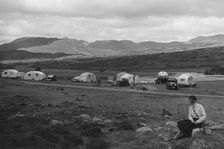 Group of cars and caravans camping in Scottish Highlands 1930's. Creator: Unknown