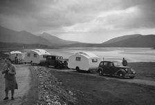 Group of cars and caravans camping in Scottish Highlands 1930's. Creator: Unknown