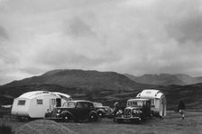 Group of cars and caravans camping in Scottish Highlands 1930's. Creator: Unknown